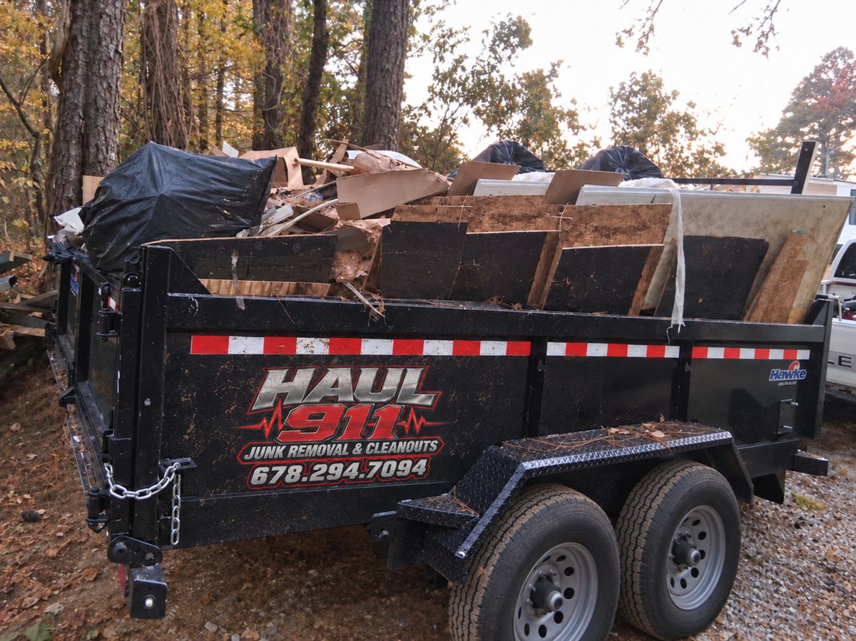Haul 911 dump trailer full of construction debris and boxes